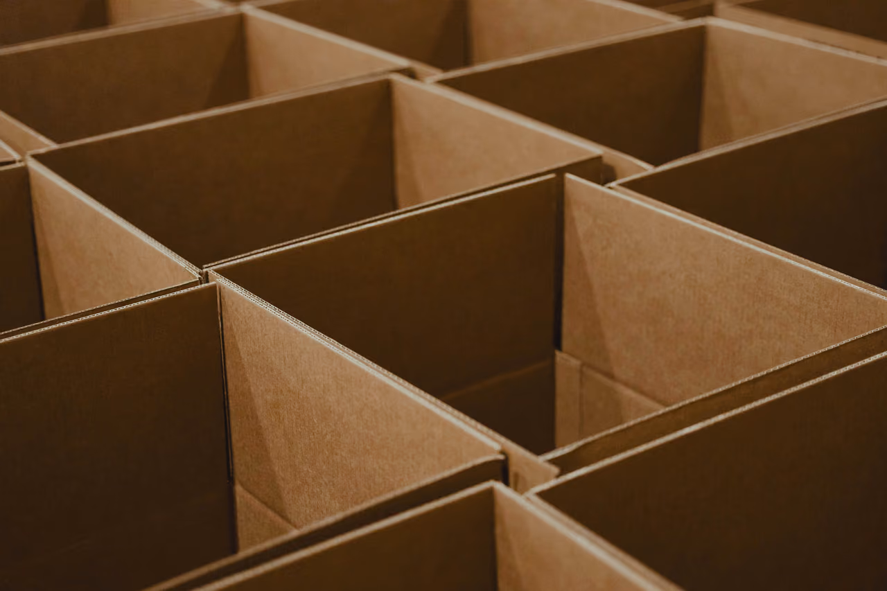 Rows of open, empty cardboard boxes standing side by side