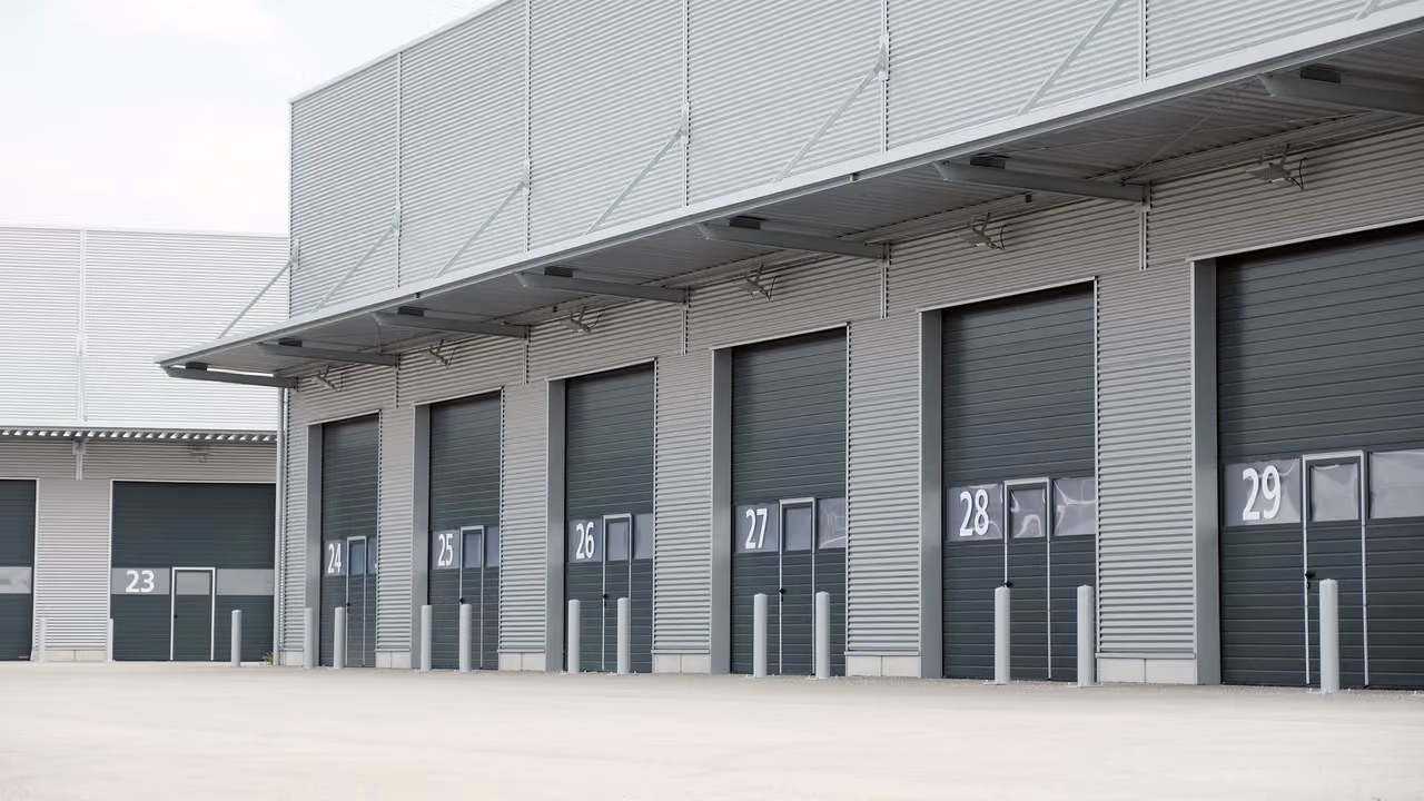 Numbered loading dock doors along a new logistics building
