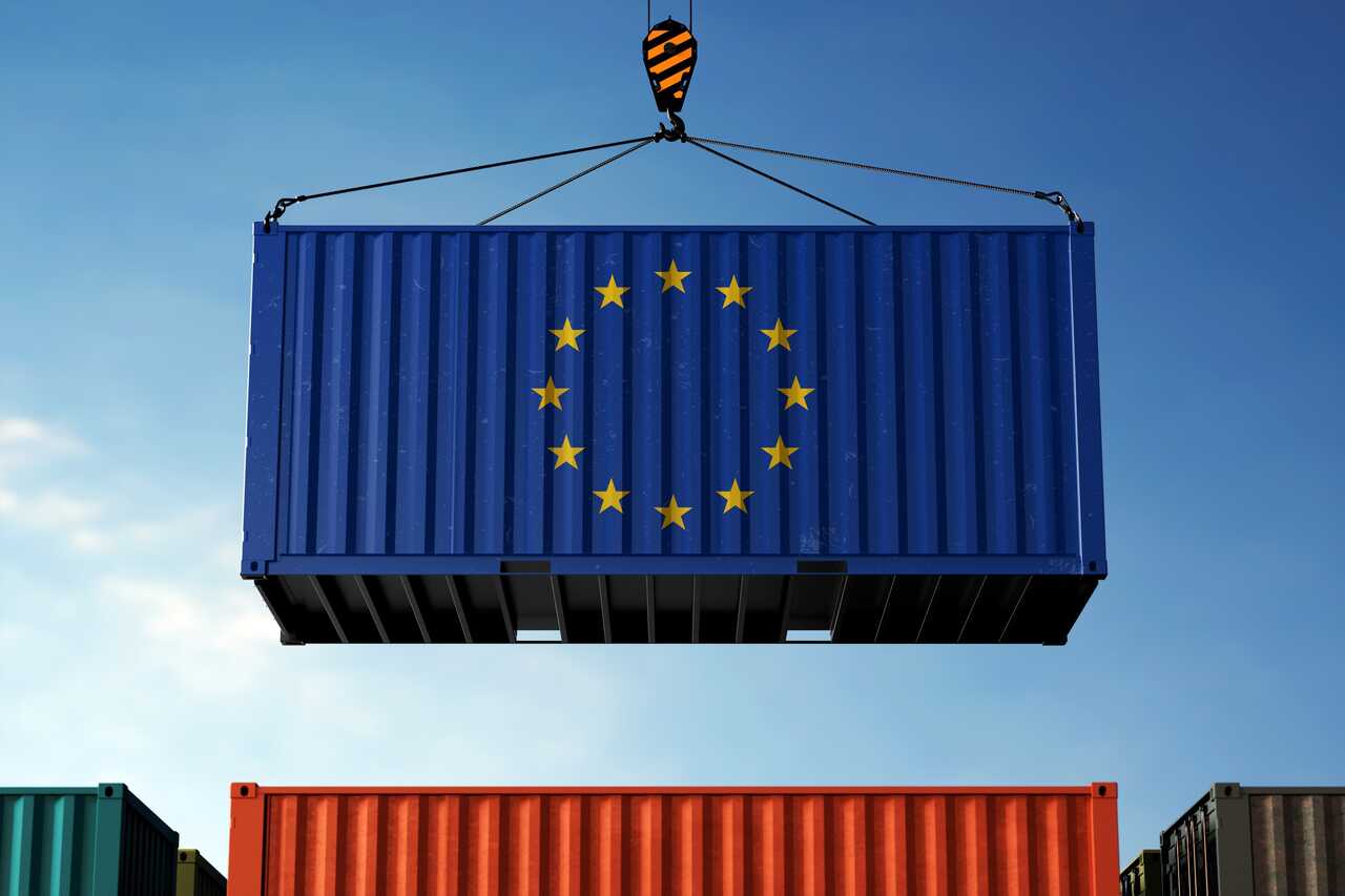 Shipping container with EU flag lifted by a crane