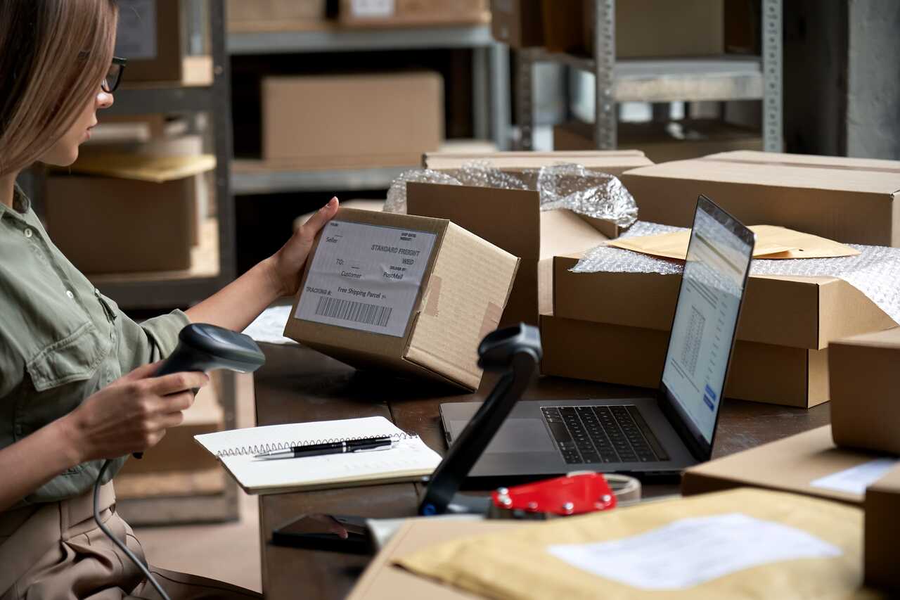 Online seller scanning a parcel barcode before shipping